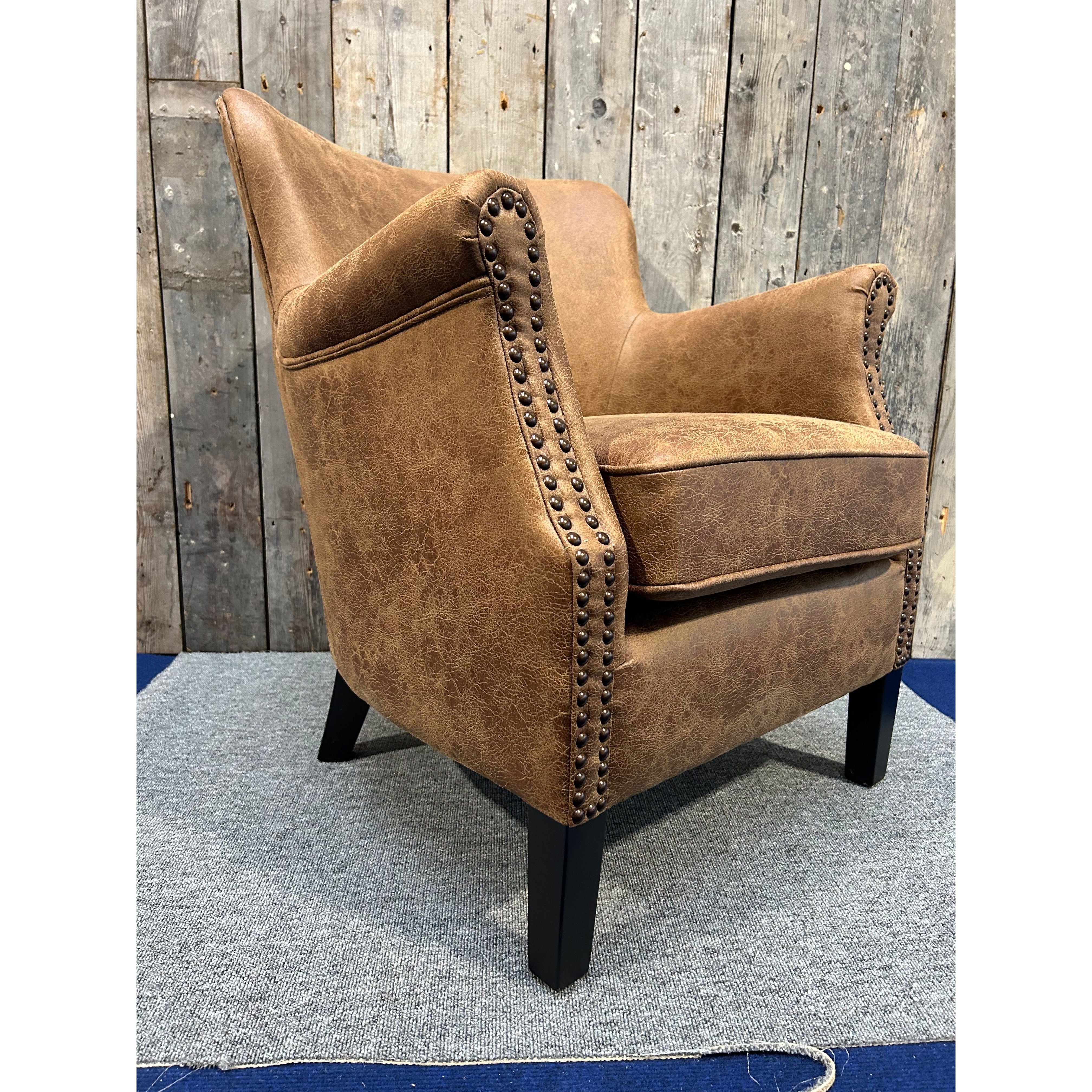 Havenheim Furniture Cromarty armchair in vegan vintage leather with plush cushioning and wooden legs, stylish and comfortable seating.