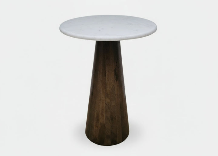 Small round table with a white marble  top and dark wooden cone-shaped base on a white background