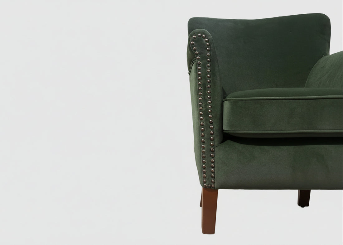 Ancient Mariner Cromarty armchair in forest green velvet with plush upholstery and wooden legs, stylish seating for living room.