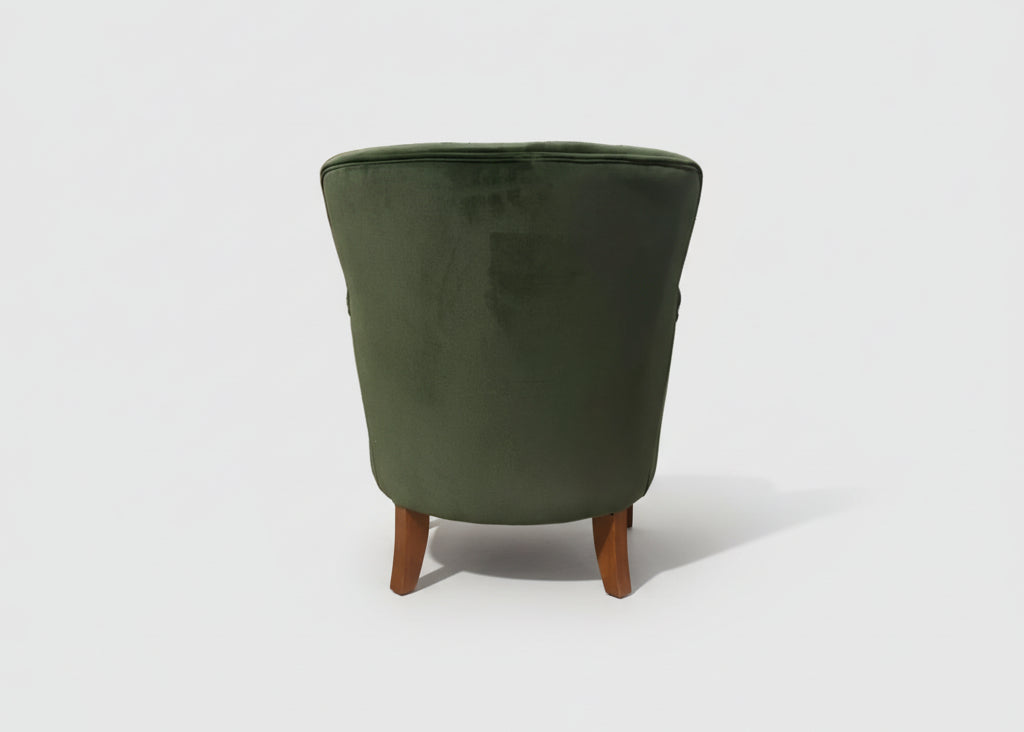 Ancient Mariner Cromarty armchair in forest green velvet with plush upholstery and wooden legs, stylish seating furniture.