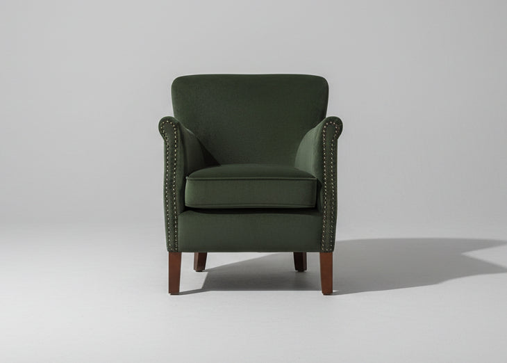 Ancient Mariner Cromarty armchair in forest green velvet with plush upholstery and wooden legs, stylish seating for living rooms.