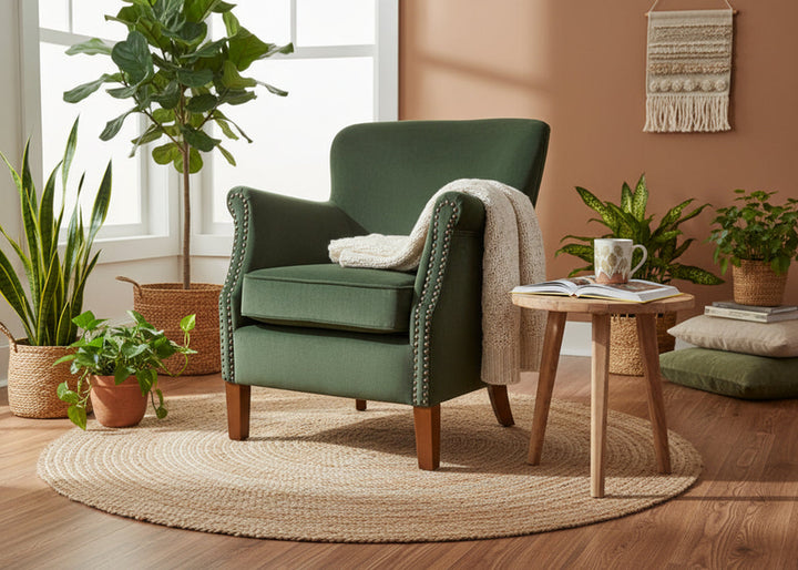 Forest green velvet Cromarty armchair by Ancient Mariner, featuring plush upholstery and stylish armrests, perfect for living room seating.