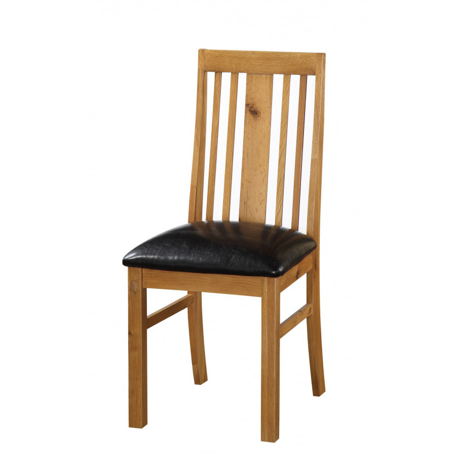 Pair of Acorn Solid Oak Dining Chairs from Heartlands Furniture with curved backs and sturdy wooden legs.