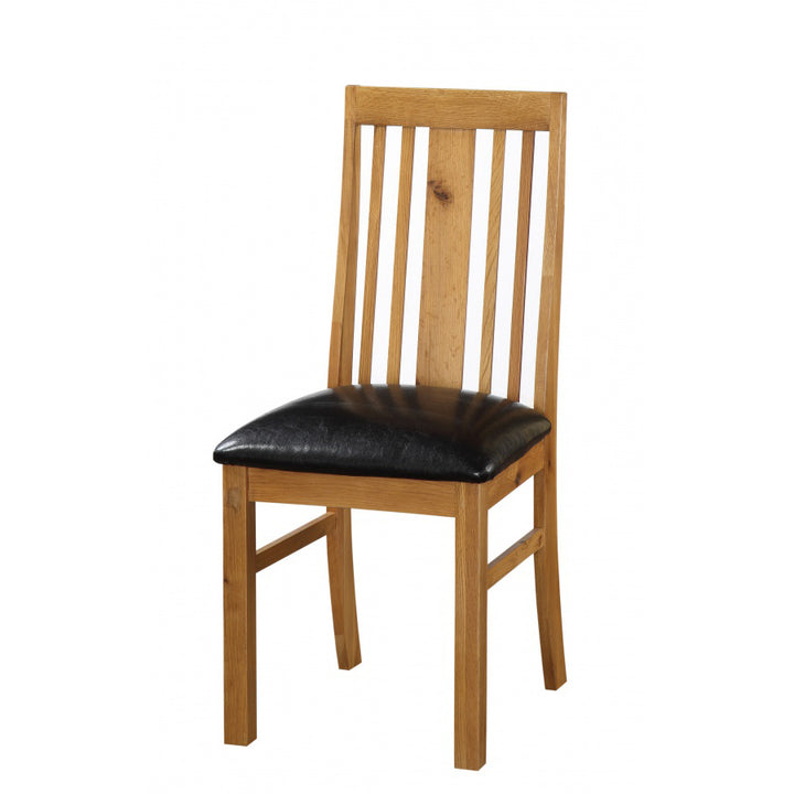Pair of Acorn Solid Oak Dining Chairs from Heartlands Furniture with curved backs and sturdy wooden legs.