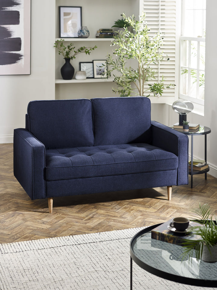 Deep blue linen upholstered 2-seater sofa by Julian Bowen, featuring plush cushions and a stylish, contemporary design.