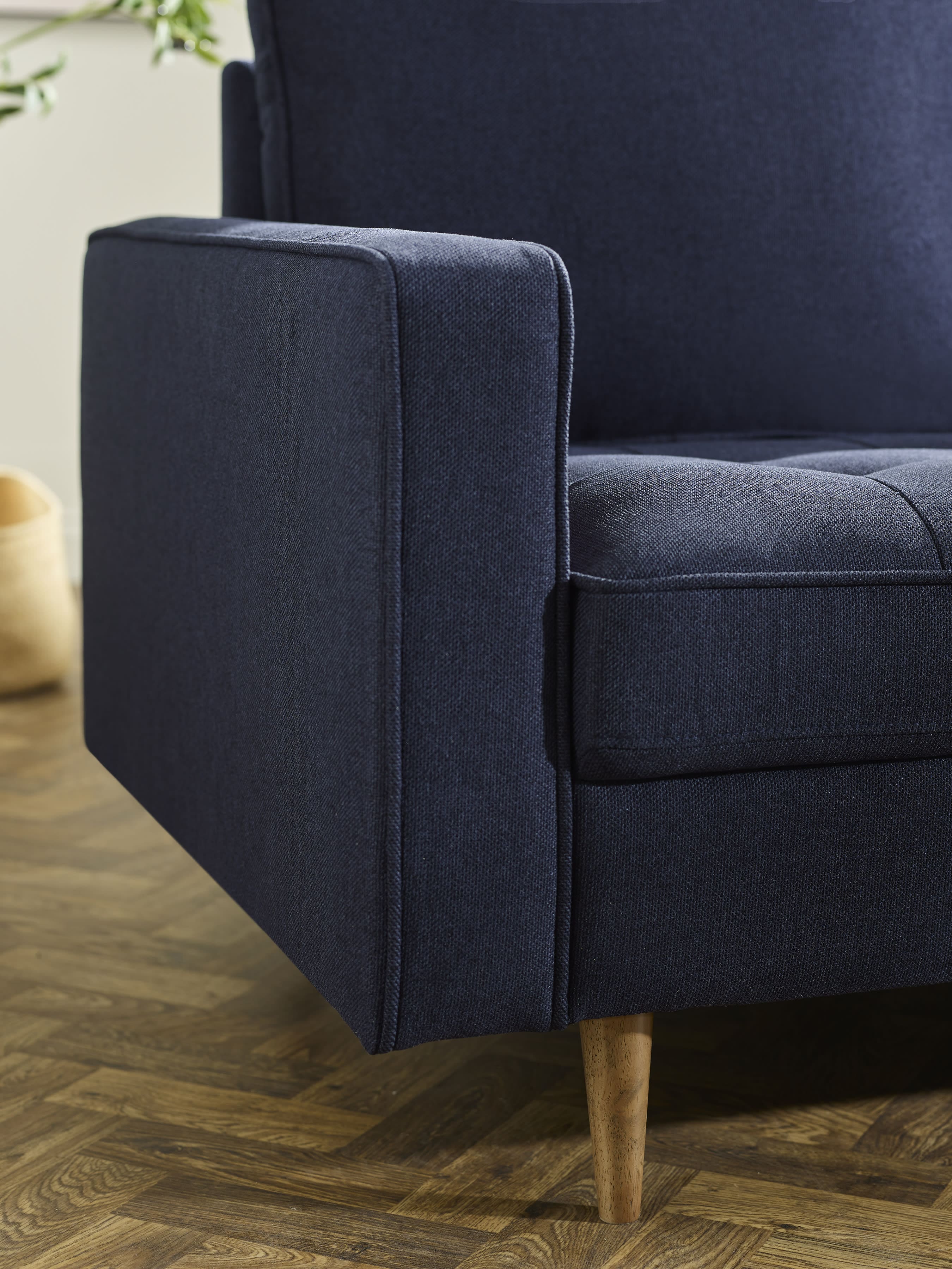 Deep blue linen upholstered 2-seater sofa from Julian Bowen with armrests and wooden legs, modern furniture for living rooms.